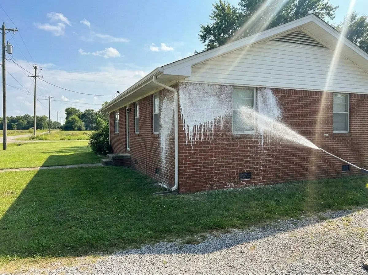 Soft washing a brick home, cleaning foam sheeting down the wall