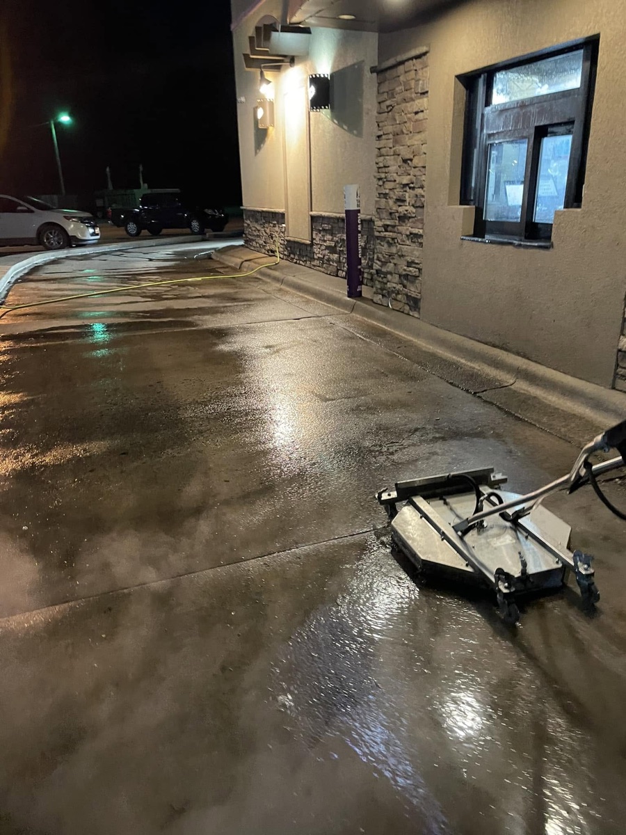 Legacy cleaning a restaurant drive-thru lane late at night